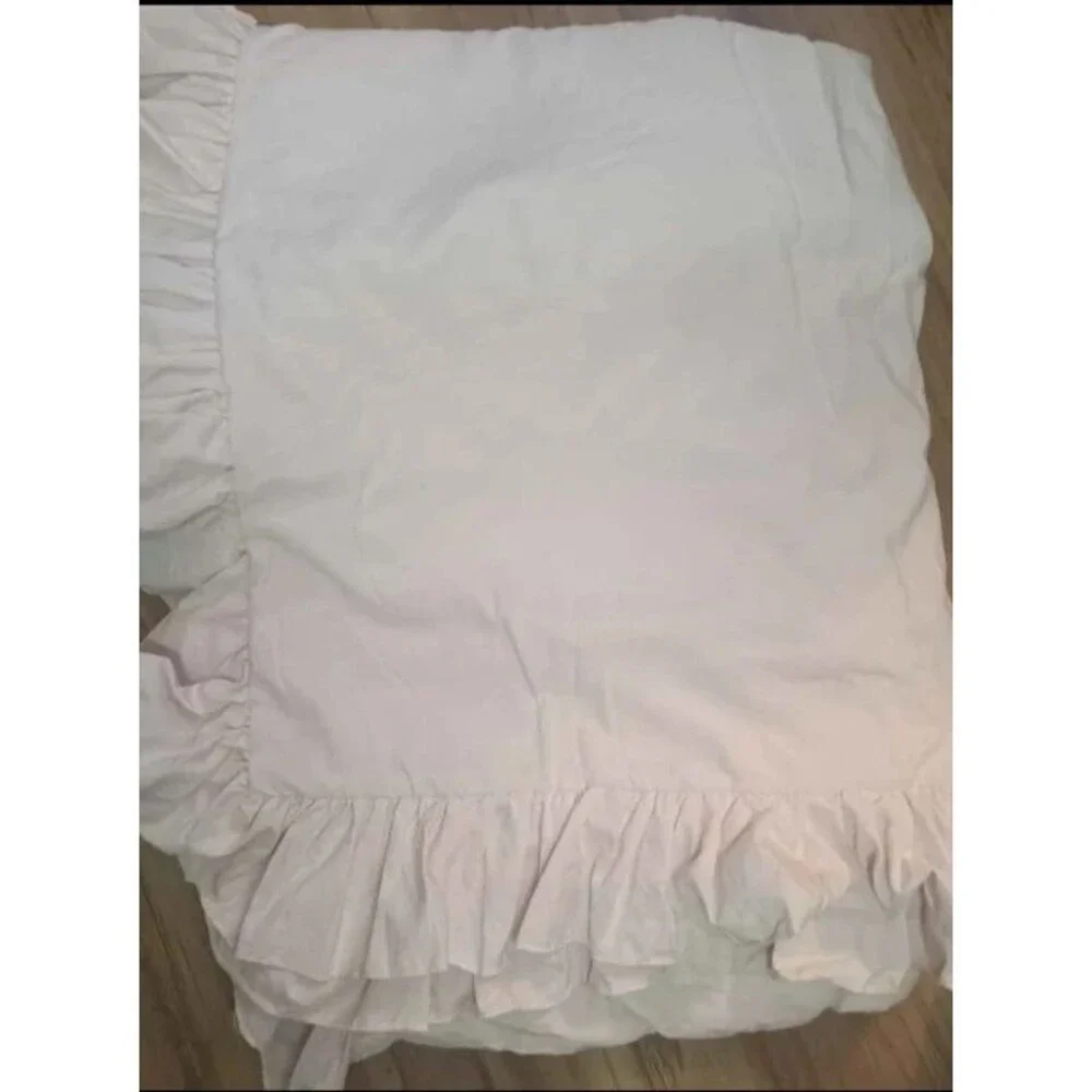 Light pink twin duvet cover with pillow sham. Ruffled edges and button close